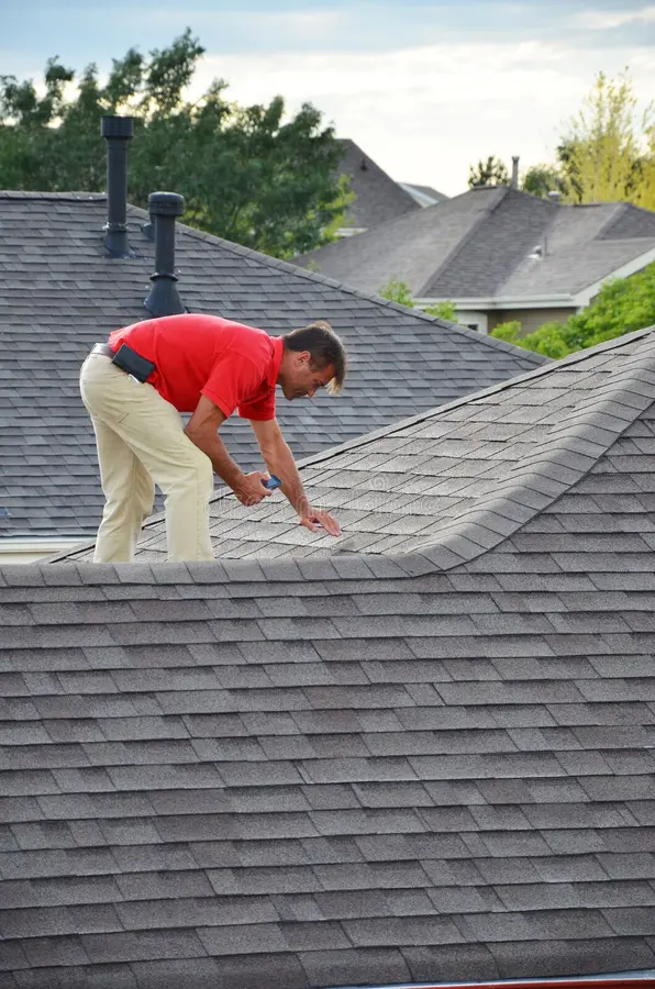 Roofer inspecting a residential roof